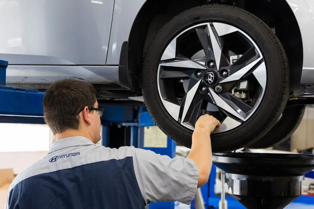 Hyundai Service Employee Working on Car Tire