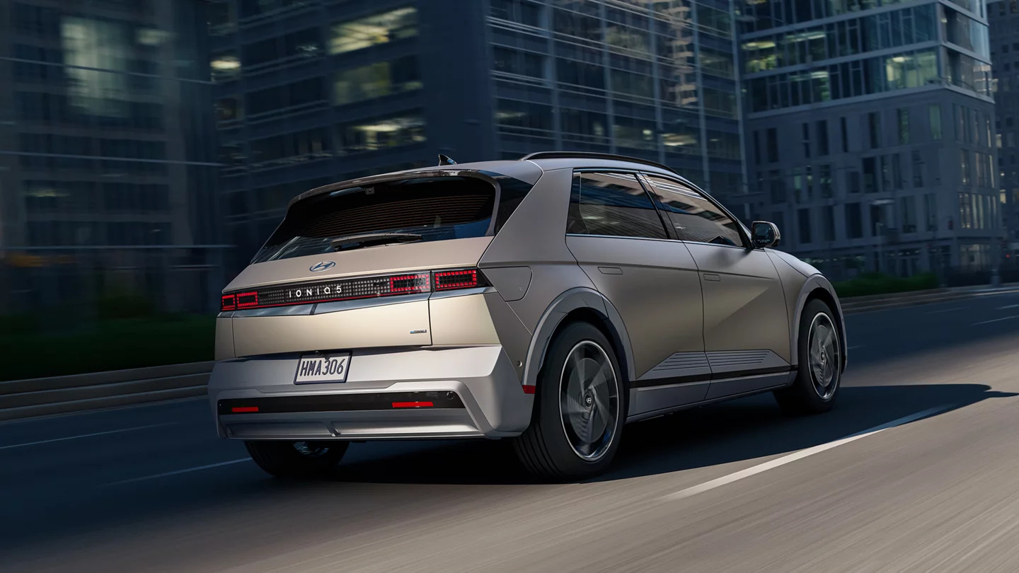 Rear view of a Hyundai Ioniq 5 driving through a city street
