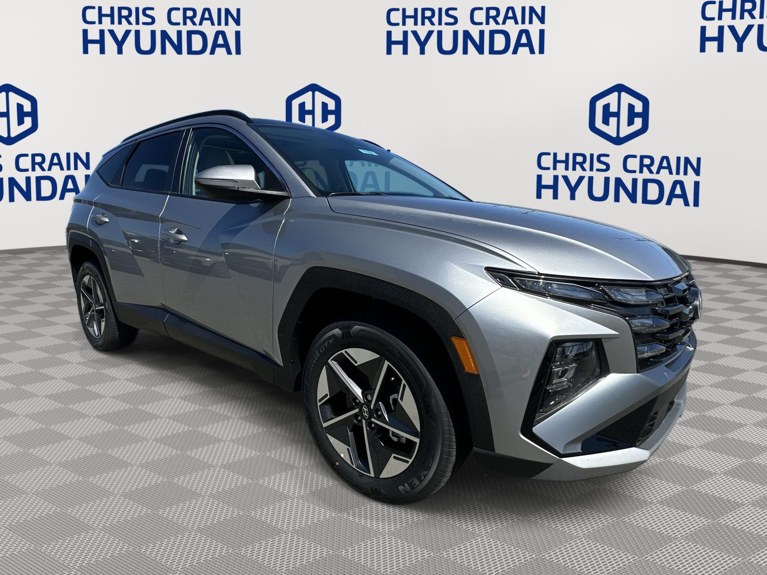 Front-side view of a silver 2025 Hyundai Tucson Hybrid parked at Chris Crain Hyundai